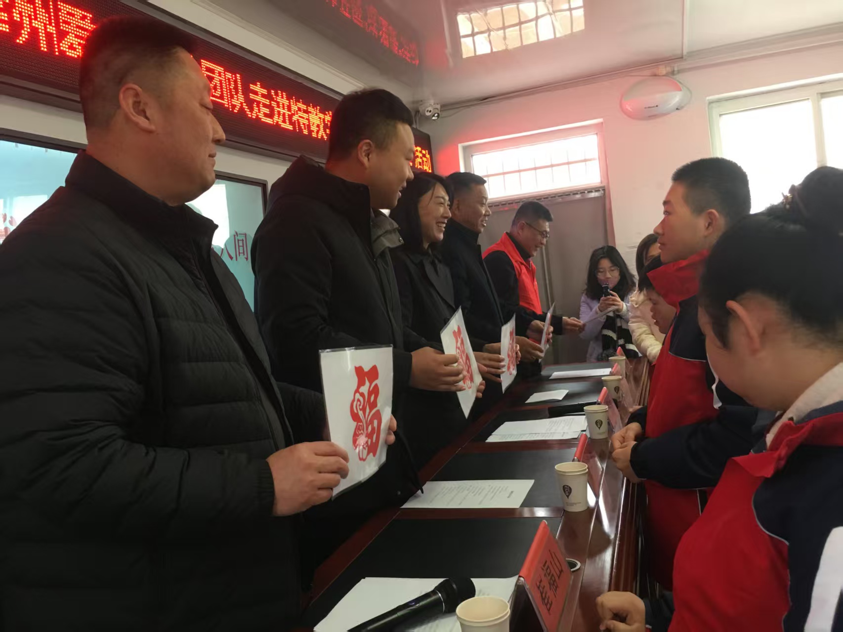 共青團遵化市委開展暖冬捐贈活動 情暖特殊兒童成長路_fororder_學生代表向公益團隊送上親手製作的福字剪紙。徐文傑攝