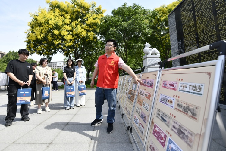 河北省遷安市開展“6·9國際檔案日”宣傳活動_fororder_工作人員向市民介紹檔案裏的生活票證。梁玉水攝.JPG