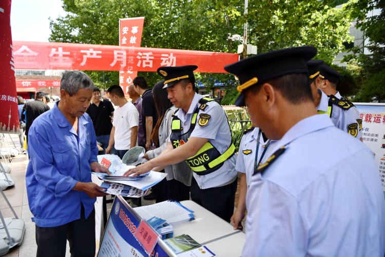遷安市開展“安全生産月”諮詢日活動_fororder_志願者為市民發放宣傳資料。梁玉水攝.JPG