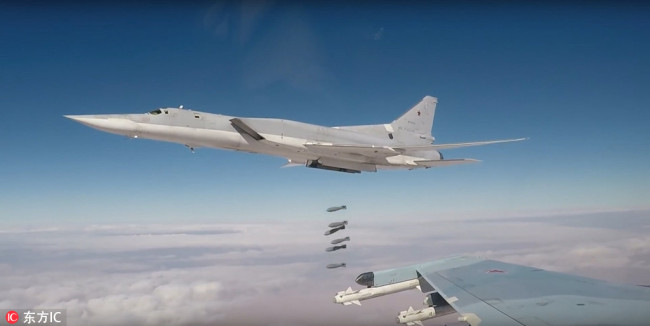 A Russian TU-22M3 long-range strategic bomber, deployed from an air base in Russia's territory, dropping bombs targeting Islamic State objects in Syria, November 26, 2017. [Photo: IC]