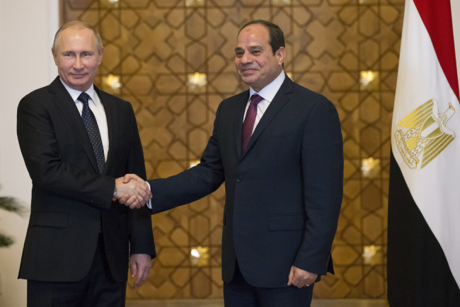 Russian President Vladimir Putin, left, and Egyptian President Abdel-Fattah El-Sissi, shake hands during their meeting in Cairo, Egypt, December 11, 2017. [Photo: AP/Alexander Zemlianichenko]