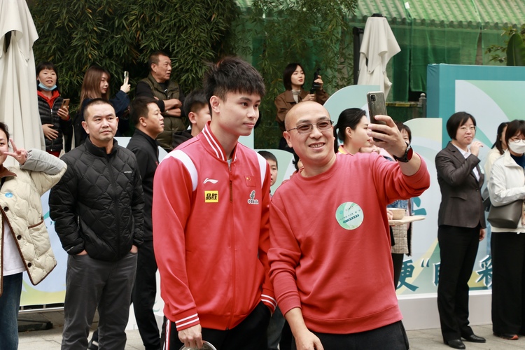 乒乓球國手進社區 感受成都賽事名城的萬千氣象_fororder_周啟豪與居民代表合影留念 攝影 楊雯涵
